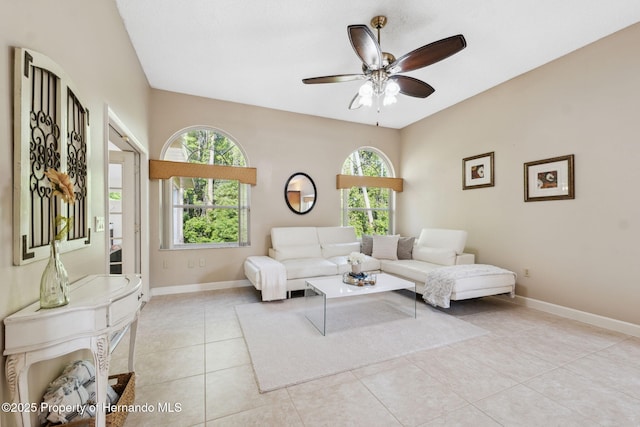 4469 Lake In The Woods Dr, Weeki Wachee, FL 34607 - living area with light tile patterned floors, ceiling fan, and baseboards