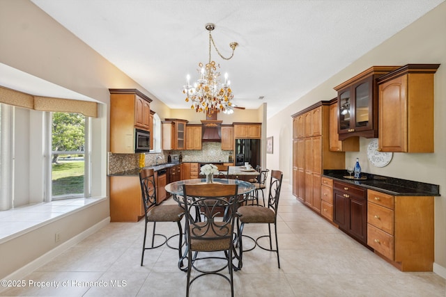 4469 Lake In The Woods Dr, Weeki Wachee, FL 34607 - dining area with light tile patterned flooring, an inviting chandelier, and baseboards