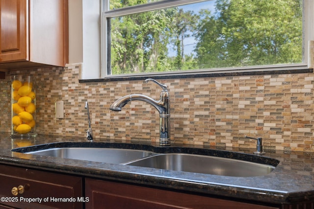 4469 Lake In The Woods Dr, Weeki Wachee, FL 34607 - interior details with dark stone counters, tasteful backsplash, and a sink