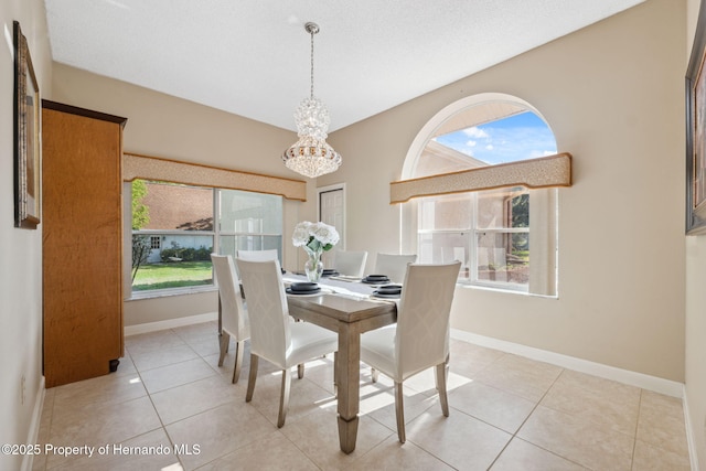 4469 Lake In The Woods Dr, Weeki Wachee, FL 34607 - tiled dining room featuring a chandelier and baseboards