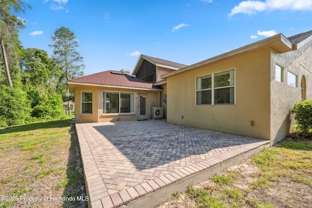 4469 Lake In The Woods Dr, Weeki Wachee, FL 34607 - back of house featuring a patio, stucco siding, and ac unit