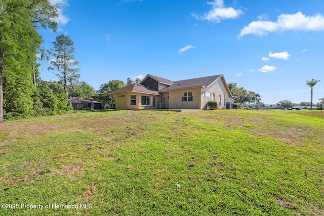 4469 Lake In The Woods Dr, Weeki Wachee, FL 34607 - exterior space with a yard, stucco siding, and a chimney