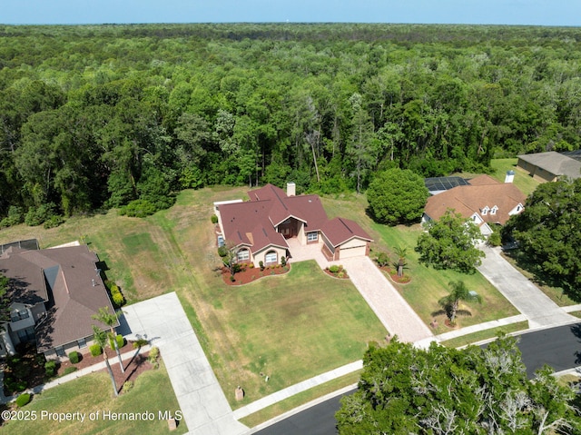 4469 Lake In The Woods Dr, Weeki Wachee, FL 34607 - aerial view featuring a wooded view