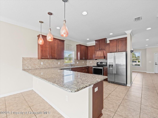 kitchen with appliances with stainless steel finishes, a peninsula, a sink, backsplash, and crown molding