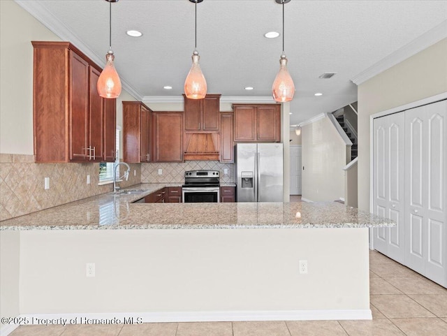 kitchen featuring stainless steel appliances, a sink, ornamental molding, light stone countertops, and a peninsula