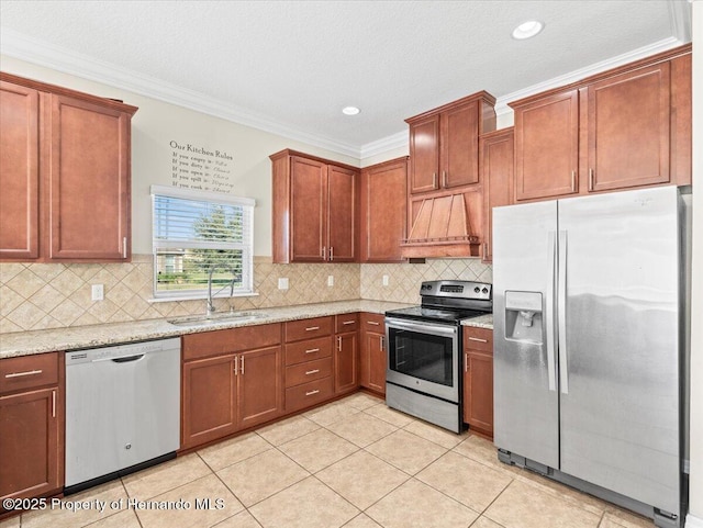 kitchen with stainless steel appliances, a sink, premium range hood, light tile patterned floors, and light stone counters