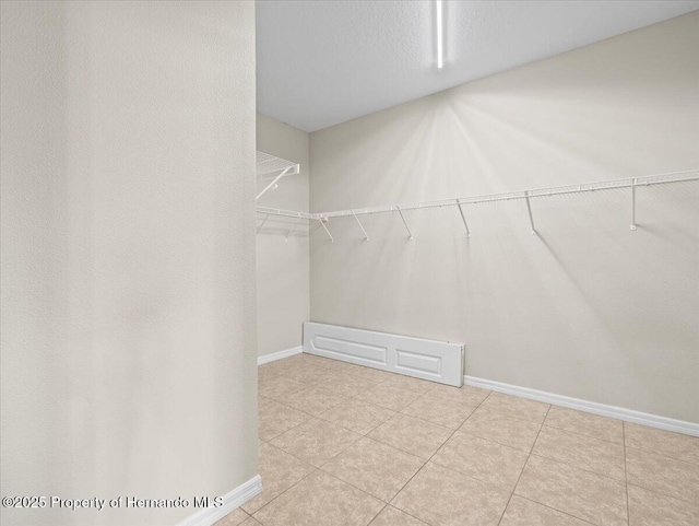 walk in closet with tile patterned flooring
