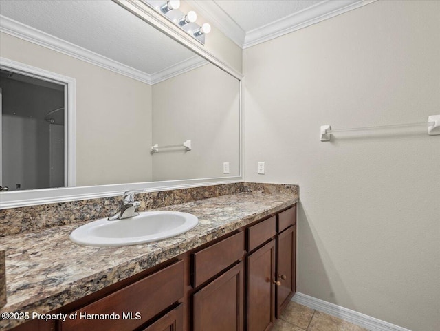 bathroom with vanity, baseboards, ornamental molding, and tile patterned floors