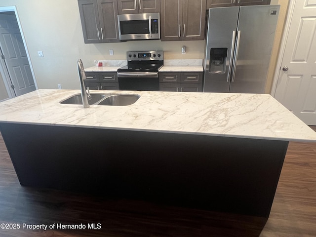 15297 Myland Rd, Weeki Wachee, FL 34614 - kitchen with light stone countertops, an island with sink, stainless steel appliances, dark wood-style flooring, and a sink