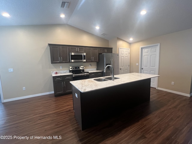 15297 Myland Rd, Weeki Wachee, FL 34614 - kitchen with lofted ceiling, a sink, visible vents, stainless steel appliances, and a kitchen island with sink
