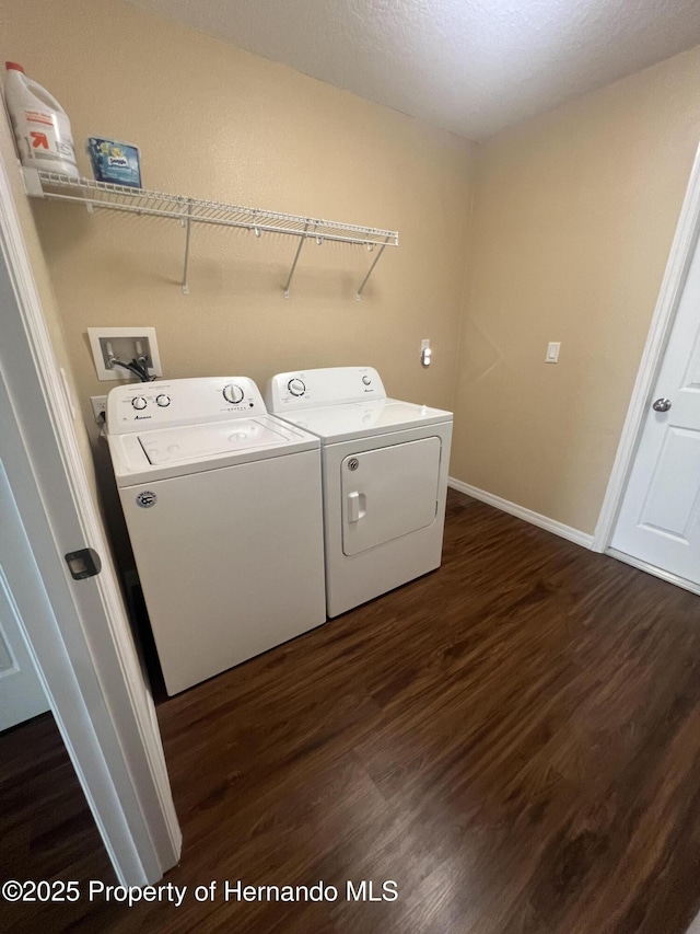 15297 Myland Rd, Weeki Wachee, FL 34614 - washroom with washer and dryer, baseboards, laundry area, and dark wood finished floors