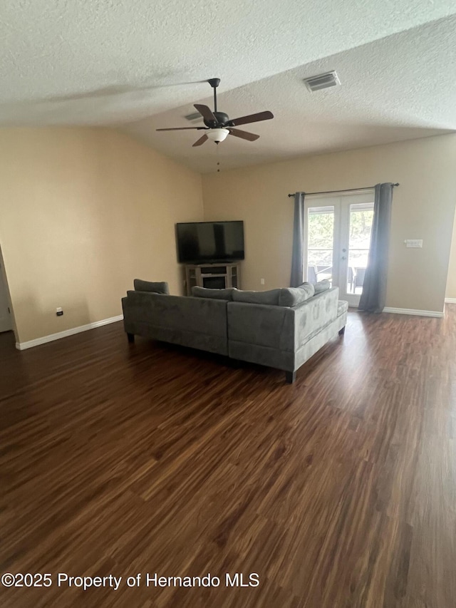 15297 Myland Rd, Weeki Wachee, FL 34614 - living room with a ceiling fan, a textured ceiling, visible vents, and dark wood-style flooring