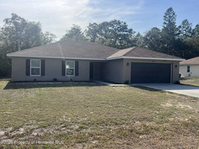 15297 Myland Rd, Weeki Wachee, FL 34614 - ranch-style house with an attached garage, a front yard, driveway, and stucco siding