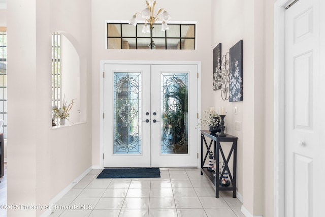 9208 Butler Blvd, Weeki Wachee, FL 34613 - entrance foyer featuring a high ceiling, a chandelier, french doors, and baseboards