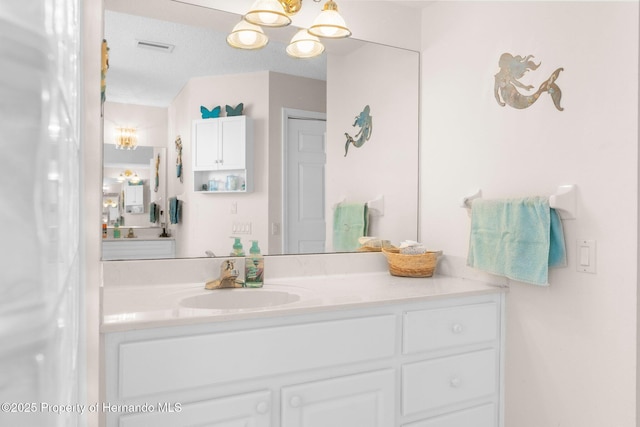 9208 Butler Blvd, Weeki Wachee, FL 34613 - bathroom with a chandelier, visible vents, and vanity
