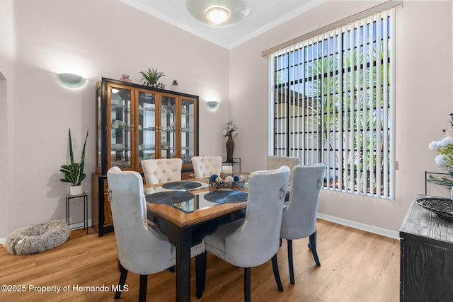 9208 Butler Blvd, Weeki Wachee, FL 34613 - dining area featuring crown molding, light wood-style flooring, and baseboards