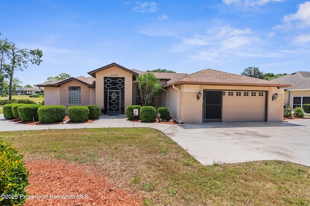 9208 Butler Blvd, Weeki Wachee, FL 34613 - ranch-style house with driveway, a front lawn, an attached garage, and brick siding