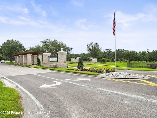 6063 Dusk Rose Ln, Brooksville, FL 34601 - view of asphalt street with view of wooded area, curbs, and street lighting