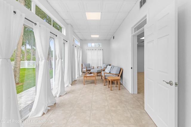 living area featuring light tile patterned flooring and visible vents