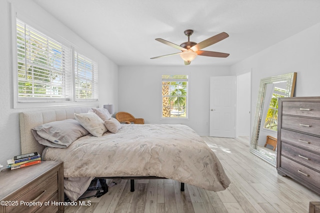 bedroom with ceiling fan and light wood-style floors