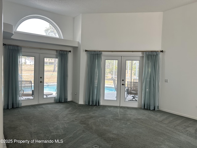 10519 Audie Brook Dr, Spring Hill, FL 34608 - carpeted entrance foyer featuring french doors, plenty of natural light, and a towering ceiling