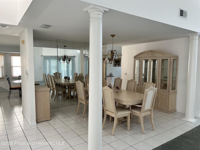 10519 Audie Brook Dr, Spring Hill, FL 34608 - dining area featuring a chandelier, decorative columns, light tile patterned floors, and baseboards