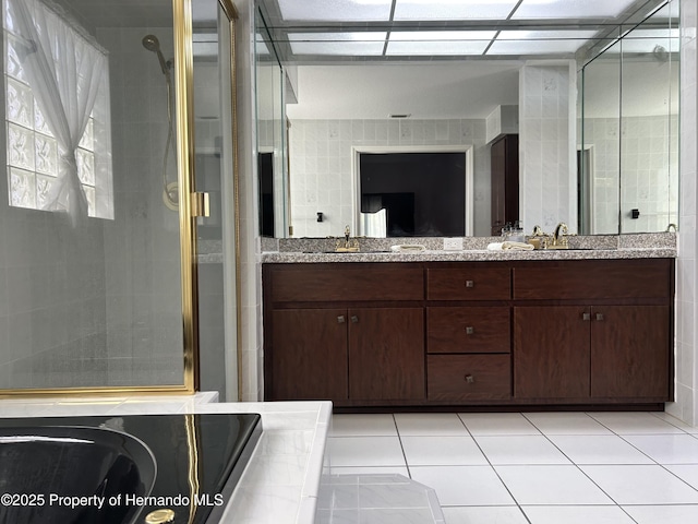 10519 Audie Brook Dr, Spring Hill, FL 34608 - full bathroom with a shower stall, double vanity, and tile patterned floors