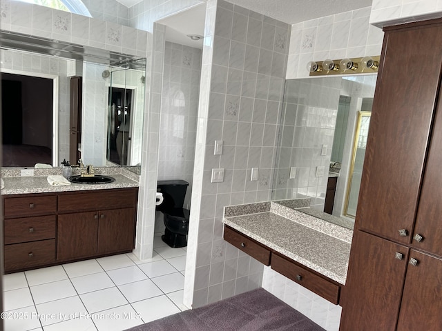 10519 Audie Brook Dr, Spring Hill, FL 34608 - bathroom with tile walls, tile patterned flooring, toilet, and vanity