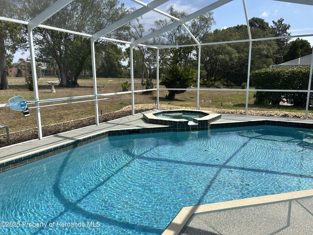 10519 Audie Brook Dr, Spring Hill, FL 34608 - view of swimming pool with glass enclosure, a pool with connected hot tub, and a patio