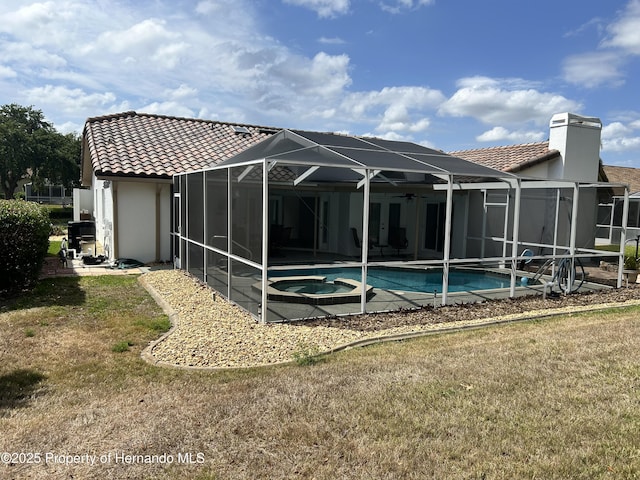 10519 Audie Brook Dr, Spring Hill, FL 34608 - rear view of property featuring a tiled roof, a yard, a patio area, and stucco siding