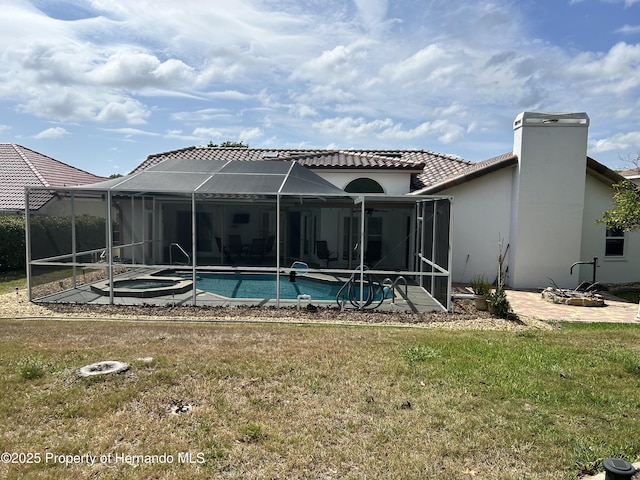 10519 Audie Brook Dr, Spring Hill, FL 34608 - rear view of house with a patio area, a yard, stucco siding, and a tile roof