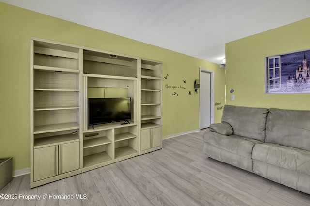 11257 Persimmon Ave, Weeki Wachee, FL 34614 - living room featuring wood finished floors and baseboards