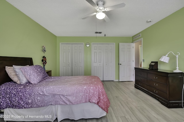 11257 Persimmon Ave, Weeki Wachee, FL 34614 - bedroom featuring a ceiling fan, visible vents, wood finished floors, and multiple closets