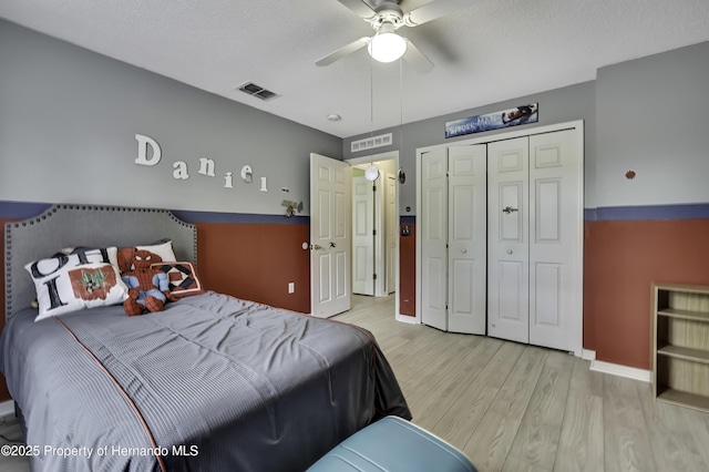 11257 Persimmon Ave, Weeki Wachee, FL 34614 - bedroom with a closet, visible vents, wood finished floors, and baseboards