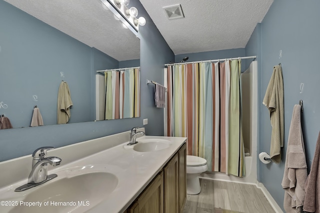11257 Persimmon Ave, Weeki Wachee, FL 34614 - full bath featuring toilet, a sink, wood finished floors, and visible vents
