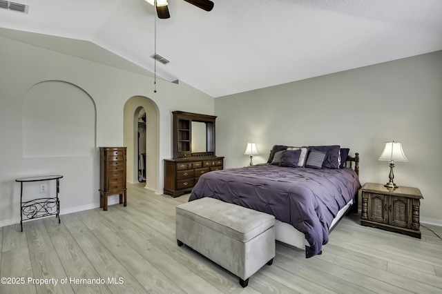 11257 Persimmon Ave, Weeki Wachee, FL 34614 - bedroom with arched walkways, visible vents, light wood-style flooring, and lofted ceiling