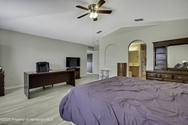 11257 Persimmon Ave, Weeki Wachee, FL 34614 - bedroom with lofted ceiling, visible vents, light wood finished floors, and arched walkways