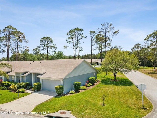 18441 Whitacre Cir, Hudson, FL 34667 - view of front of home with stucco siding, concrete driveway, a front yard, and an attached garage