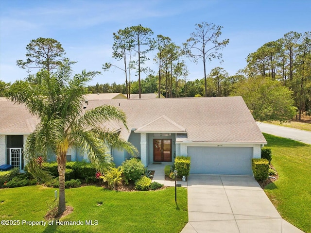 18441 Whitacre Cir, Hudson, FL 34667 - ranch-style house with a front lawn, driveway, and an attached garage