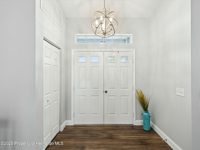 18441 Whitacre Cir, Hudson, FL 34667 - foyer with baseboards, a notable chandelier, and dark wood-style floors