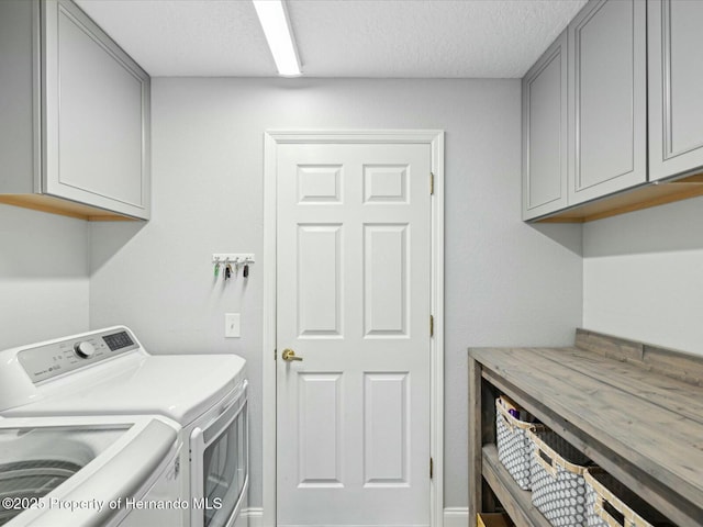 18441 Whitacre Cir, Hudson, FL 34667 - washroom featuring a textured ceiling, cabinet space, and washing machine and clothes dryer