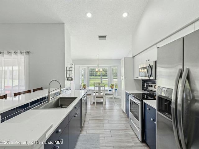 18441 Whitacre Cir, Hudson, FL 34667 - kitchen featuring a sink, visible vents, light countertops, a textured ceiling, and appliances with stainless steel finishes