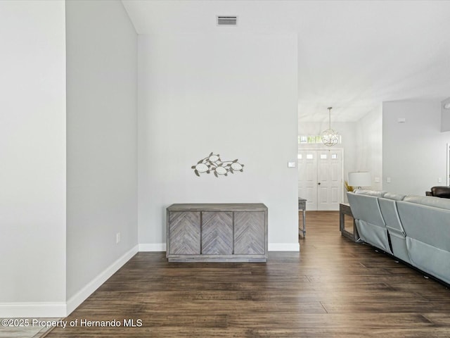 18441 Whitacre Cir, Hudson, FL 34667 - interior space featuring wood finished floors, visible vents, a notable chandelier, and baseboards