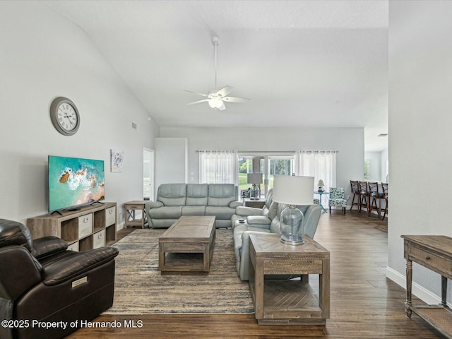 18441 Whitacre Cir, Hudson, FL 34667 - living room with a ceiling fan, high vaulted ceiling, wood finished floors, and baseboards