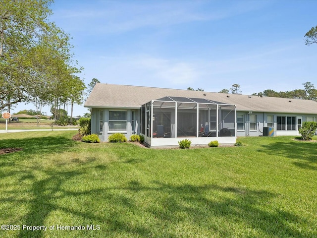 18441 Whitacre Cir, Hudson, FL 34667 - rear view of house with cooling unit, a yard, and glass enclosure