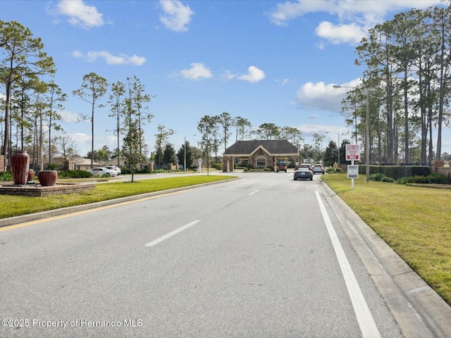 18441 Whitacre Cir, Hudson, FL 34667 - view of street featuring traffic signs, curbs, and street lights