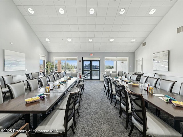 18441 Whitacre Cir, Hudson, FL 34667 - carpeted dining area featuring visible vents, high vaulted ceiling, and recessed lighting