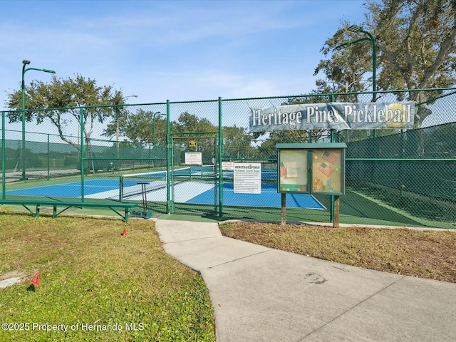 18441 Whitacre Cir, Hudson, FL 34667 - view of sport court featuring a gate and fence