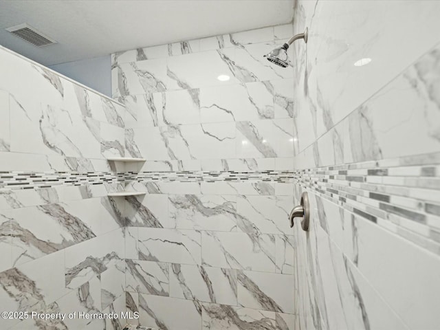 room details featuring visible vents and tiled shower
