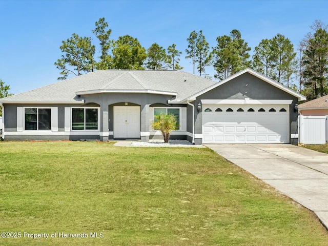 ranch-style home with driveway, roof with shingles, a front yard, stucco siding, and a garage